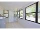 This sun room features tile floors, several large windows, and a white door at 1475 Lowrie Ave, Orlando, FL 32805