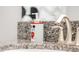 Close-up of a bathroom sink featuring a Mickey Mouse-themed soap dispenser on granite countertop at 1628 Moon Valley Dr, Davenport, FL 33896
