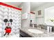 Bathroom featuring a Mickey Mouse themed shower curtain, granite countertops, and modern fixtures at 1628 Moon Valley Dr, Davenport, FL 33896