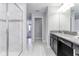 Full bathroom with tiled shower and flooring, as well as a granite countertop and sink with dark cabinets at 1628 Moon Valley Dr, Davenport, FL 33896