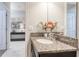 Bathroom vanity with granite countertop and view of the hallway and entryway at 1628 Moon Valley Dr, Davenport, FL 33896