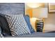 Comfortable bedroom featuring a pillow with geometric pattern and stylish lamp on a bedside table at 1628 Moon Valley Dr, Davenport, FL 33896