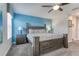 Comfortable bedroom with ceiling fan, large bed, side tables, and ensuite bathroom access at 1628 Moon Valley Dr, Davenport, FL 33896