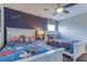 A bedroom featuring two twin beds with Disney-themed bedding and a Mickey Mouse theme at 1628 Moon Valley Dr, Davenport, FL 33896