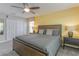 Stylish bedroom with a ceiling fan, bedside tables, lamps and coordinated yellow accents at 1628 Moon Valley Dr, Davenport, FL 33896