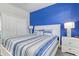 Bedroom showcasing a blue accent wall, closet, and bedside tables with lamps at 1628 Moon Valley Dr, Davenport, FL 33896