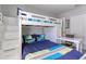 Bedroom featuring a white bunk bed, desk, and closet at 1628 Moon Valley Dr, Davenport, FL 33896