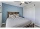 Bedroom with a queen bed, blue accent wall, ceiling fan, and double closet at 1628 Moon Valley Dr, Davenport, FL 33896