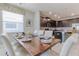 Open dining room and kitchen area with a wooden table set for a meal at 1628 Moon Valley Dr, Davenport, FL 33896