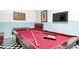 Fun game room features a pool table, an American flag on the wall, and a TV for entertainment at 1628 Moon Valley Dr, Davenport, FL 33896