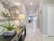 Entryway with a console table, modern light fixture, stylish decor, and light tile flooring at 1628 Moon Valley Dr, Davenport, FL 33896