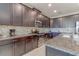 Well-appointed kitchen with dark cabinetry, granite counters, stainless steel appliances, and tile backsplash at 1628 Moon Valley Dr, Davenport, FL 33896