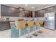 Modern kitchen with dark wood cabinets, stainless steel appliances, granite countertops, and breakfast bar seating at 1628 Moon Valley Dr, Davenport, FL 33896