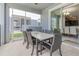 Screened-in lanai with dining area, connecting indoor and outdoor living spaces at 1628 Moon Valley Dr, Davenport, FL 33896