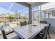 Screened lanai featuring a dining table with seating for six, perfect for outdoor entertaining at 1628 Moon Valley Dr, Davenport, FL 33896