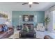 Comfortable living room with leather sofa, flat-screen TV, and ceiling fan at 1628 Moon Valley Dr, Davenport, FL 33896