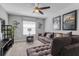 Living room with a comfy sofa, ceiling fan, and entertainment center at 1628 Moon Valley Dr, Davenport, FL 33896