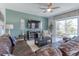 Inviting living room with plush leather sofa, large TV, and sliding glass doors to the pool area at 1628 Moon Valley Dr, Davenport, FL 33896