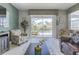 Bright living room with tile floors and a view of the screened-in lanai and pool area at 1628 Moon Valley Dr, Davenport, FL 33896