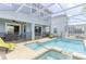 Backyard pool and patio area with screened-in enclosure, providing a private outdoor oasis at 1628 Moon Valley Dr, Davenport, FL 33896
