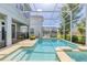 Backyard pool with spa and screened enclosure, surrounded by comfortable lounge seating at 1628 Moon Valley Dr, Davenport, FL 33896