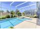 Inviting screened-in pool and spa with ample patio space for lounging and relaxing at 1628 Moon Valley Dr, Davenport, FL 33896