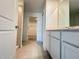 A stylish bathroom featuring white cabinets and neutral tile flooring at 1721 Teagan Ln, Winter Haven, FL 33884