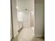 A modern bathroom with a shower and white cabinets featuring neutral tile flooring at 1721 Teagan Ln, Winter Haven, FL 33884