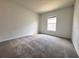 Bright bedroom with neutral carpet, fresh paint, and a window for natural light at 1721 Teagan Ln, Winter Haven, FL 33884