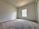 Bright bedroom with neutral carpet, fresh paint, and a window for natural light at 1721 Teagan Ln, Winter Haven, FL 33884