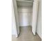 A walk-in closet with ample storage space featuring neutral walls and tiled flooring at 1721 Teagan Ln, Winter Haven, FL 33884