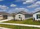Side view of single-story home, highlighting the landscaping and neighborhood setting at 1721 Teagan Ln, Winter Haven, FL 33884