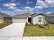 Charming single-story home with a two-car garage, landscaped yard, and welcoming entrance at 1721 Teagan Ln, Winter Haven, FL 33884