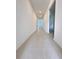 Spacious hallway with neutral tile, creating an open feel and easy access to rooms at 1721 Teagan Ln, Winter Haven, FL 33884