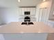 Bright kitchen with white cabinets, stainless steel appliances, and large island with sink at 1721 Teagan Ln, Winter Haven, FL 33884