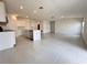An open kitchen and living room area with tile floors and stainless steel appliances at 1721 Teagan Ln, Winter Haven, FL 33884