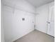 Bright laundry room featuring tile flooring and wire shelving for storage at 1721 Teagan Ln, Winter Haven, FL 33884