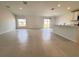 Open-concept living space with tile floors, connecting the kitchen and dining areas at 1721 Teagan Ln, Winter Haven, FL 33884