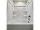 Bathroom with shower tub combo featuring white tile and chrome hardware at 1721 Teagan Ln, Winter Haven, FL 33884