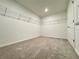 Spacious walk-in closet with carpeted floors and built-in wire shelving for optimal storage and organization at 1721 Teagan Ln, Winter Haven, FL 33884