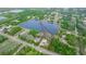 An aerial shot of the property with the home highlighted by a red border next to a tranquil lake at 19261 Quarterly Pkwy, Orlando, FL 32833
