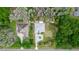 Overhead view of the house with circular driveway and lush green surroundings, next to a similar property at 19261 Quarterly Pkwy, Orlando, FL 32833