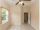 Bright bedroom featuring neutral paint, a ceiling fan, and a door to an adjacent room at 19261 Quarterly Pkwy, Orlando, FL 32833