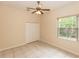 Bedroom featuring a ceiling fan, tiled floor, closet and large window at 19261 Quarterly Pkwy, Orlando, FL 32833