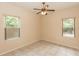 Bedroom featuring tile flooring, a ceiling fan, and dual windows for ample natural light at 19261 Quarterly Pkwy, Orlando, FL 32833