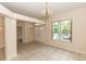 Inviting dining space featuring a chandelier and a large window with views of the lush yard at 19261 Quarterly Pkwy, Orlando, FL 32833
