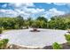 Circular driveway featuring a center island with mature palms and lush landscaping, providing ample parking at 19261 Quarterly Pkwy, Orlando, FL 32833