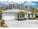Well-maintained home featuring a manicured front yard and a spacious driveway at 19261 Quarterly Pkwy, Orlando, FL 32833