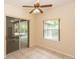 Bright Florida room with tiled floor, fan, and sliding glass doors to enjoy indoor/outdoor living at 19261 Quarterly Pkwy, Orlando, FL 32833