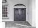 Elegant front entrance featuring a secure, decorative iron gate and detailed stonework at 19261 Quarterly Pkwy, Orlando, FL 32833